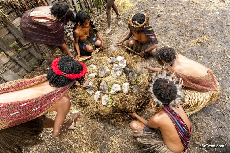 Dani women cook food in Wamena, Papua New Guinea