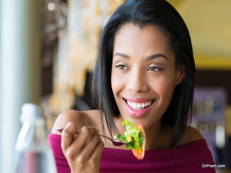 Girl eating fresh salad