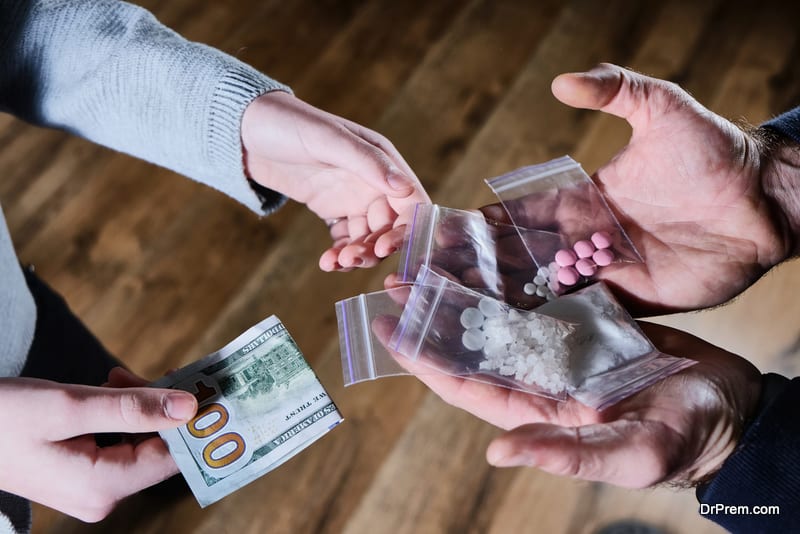 Hand of addict man with money buying dose of cocaine or heroine or another narcotic from drug dealer