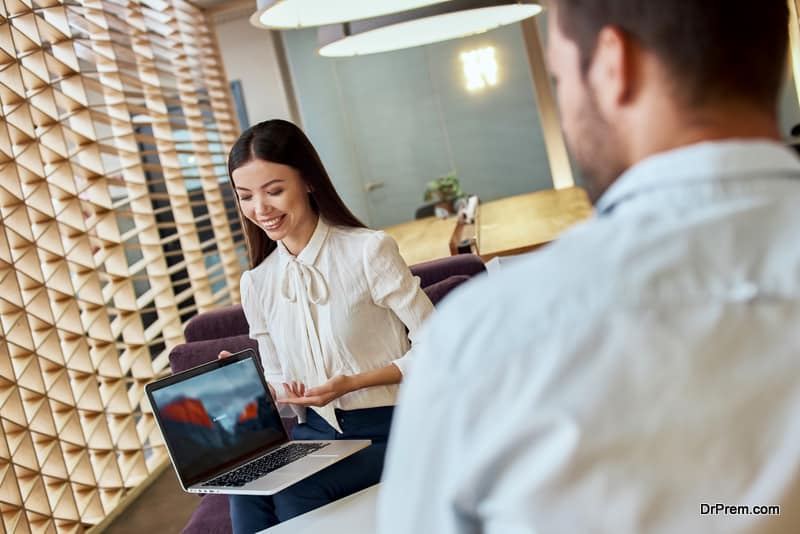 Young travel agent give a presentation to a client