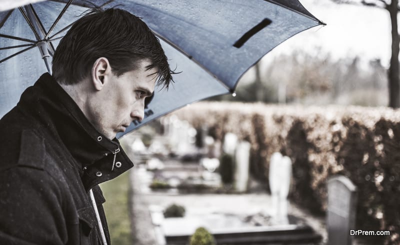 man visiting grave