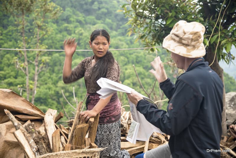 tourist man talking to local woman