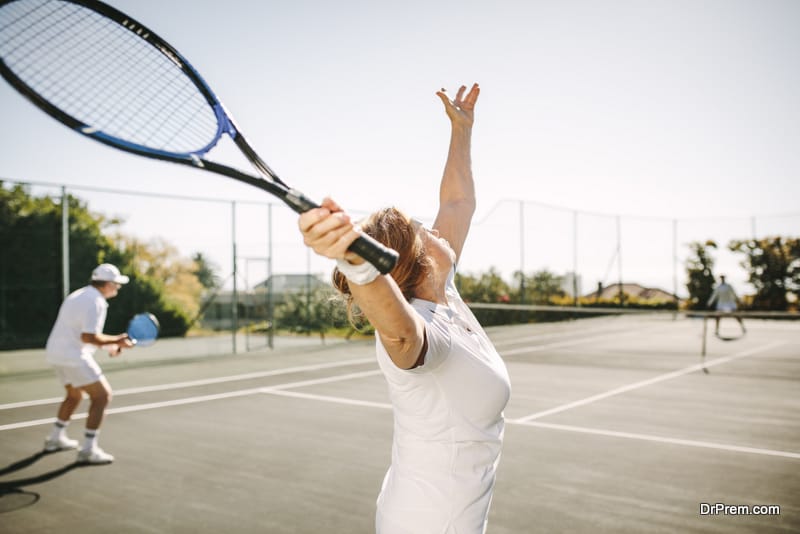 woman making a serve while playing tennis