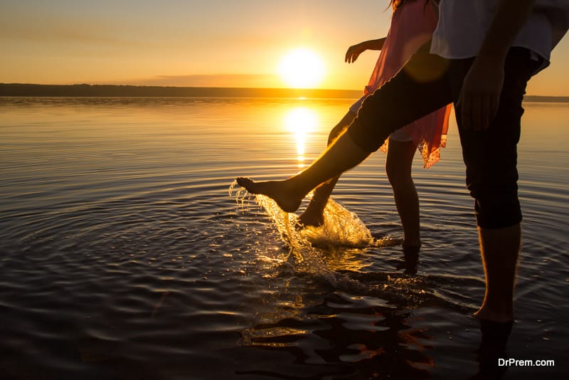 Young couples is walking in the water