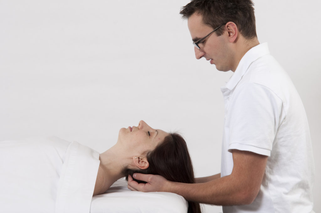 Man giving a woman cranial massage