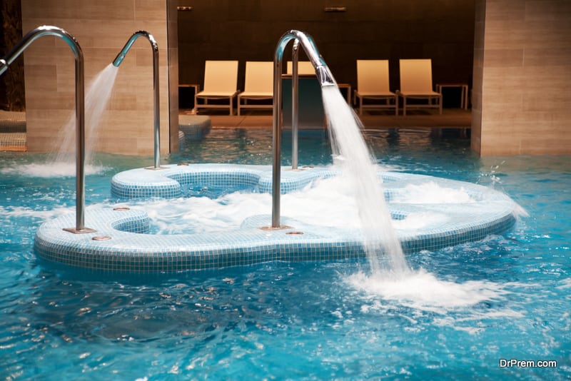 Empty indoor swimming pool with waterfall jet