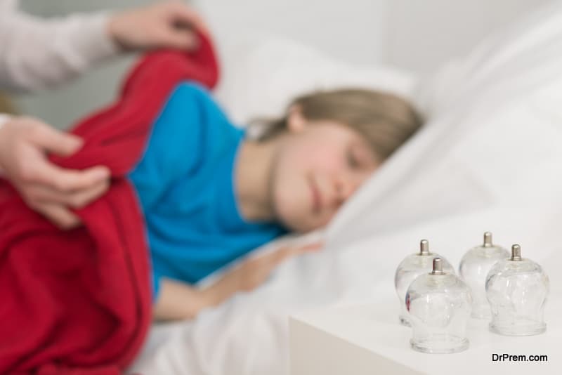 Shot of a little boy sleeping in a bed and cupping glass laying on his night table
