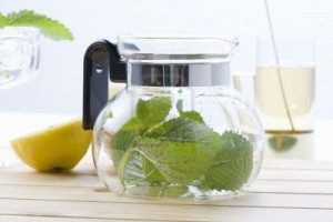 6916133-lemon-balm-leaves-in-the-tea-pot-a-cup-tea-and-lemon-on-the-wooden-board