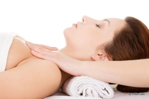 Young beautiful lying on a table at spa salon.