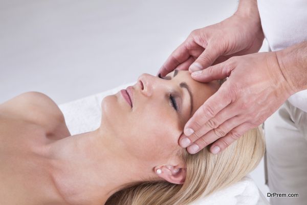 Woman Having Facial Massage In Spa Centre
