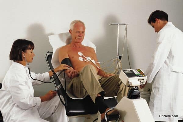 Doctors giving stress test to patient using ergometer