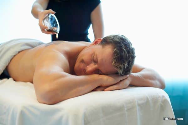 Man receiving massage with oil at spa