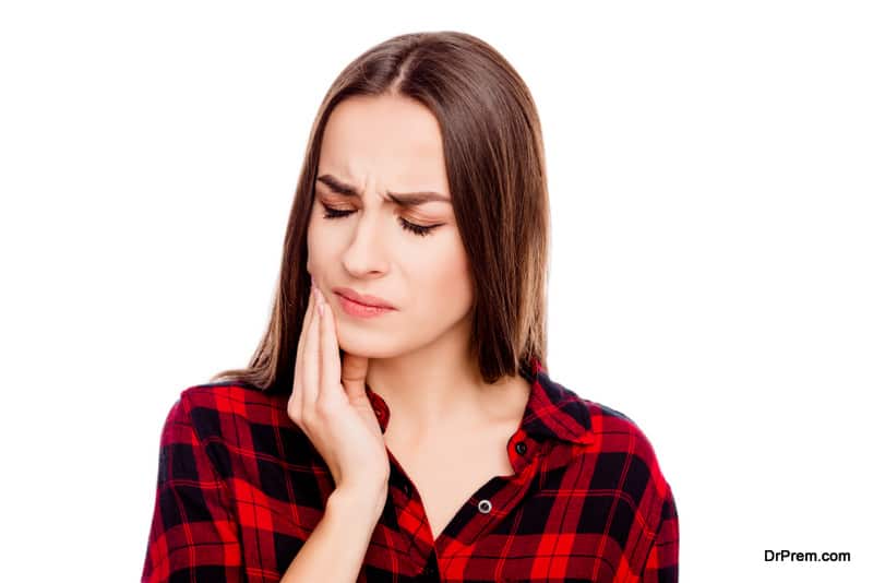 Unhappy sick woman having toothache and touching cheek