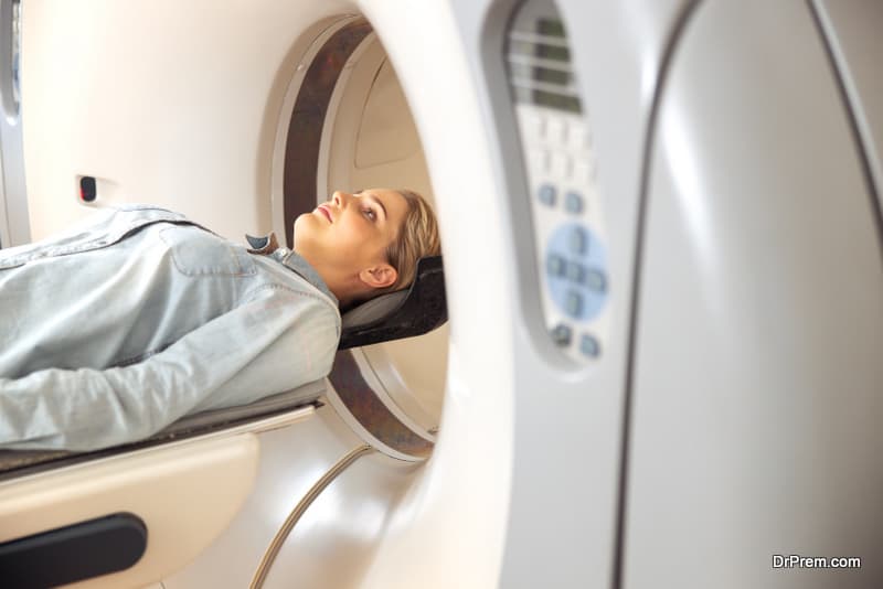 Young lady lying on CT scanner table 