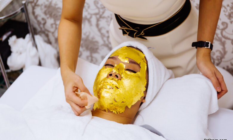 woman getting 24 karat gold facial treatment at the beauty clinic
