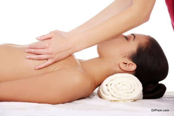 Young woman receiving breast massage at spa