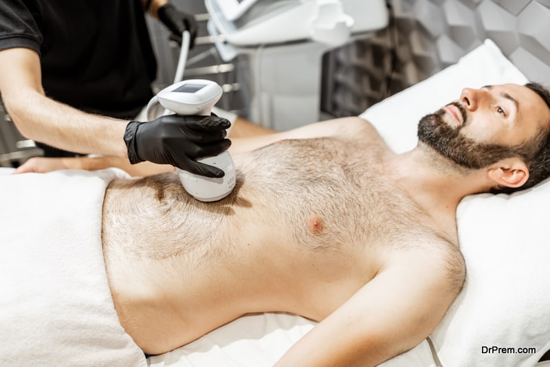 Man during an ultrasound liposuction procedure at luxury Spa salon. Doctor working on abdomen area
