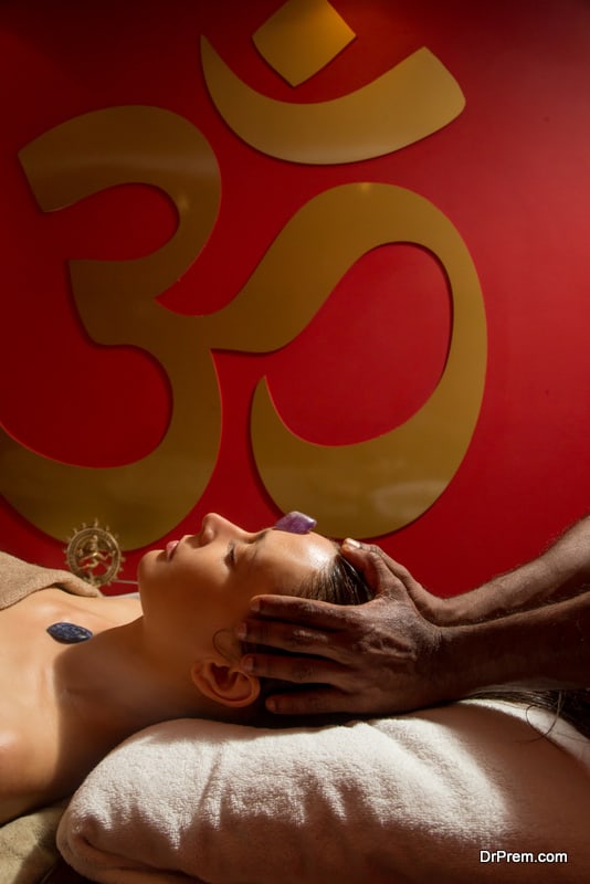 Woman in the spa having energizing crystal massage