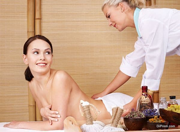 Woman on massage table in beauty spa.