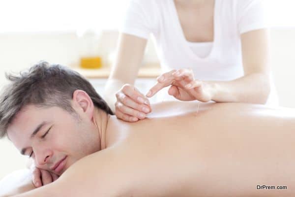 Smiling young man in an acupuncture therapy