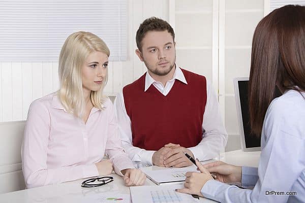 Young couple having an appointment at bank or insurance.