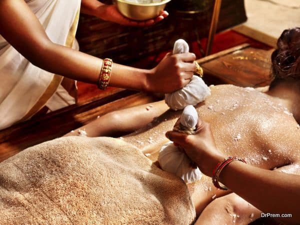 Woman having massage with pouch of rice.