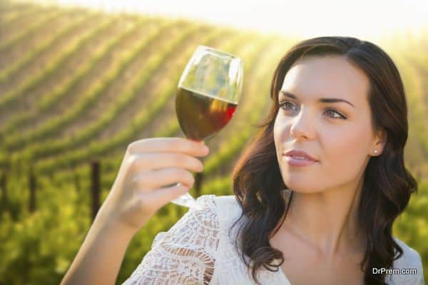 Young Adult Woman Enjoying A Glass of Wine in Vineyard