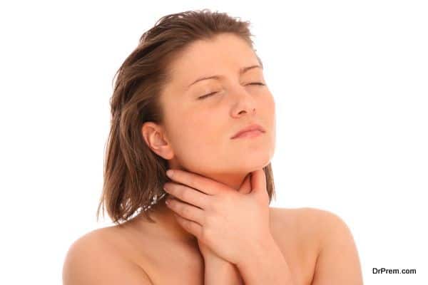 A picture of a young woman suffering from sore throat over white background
