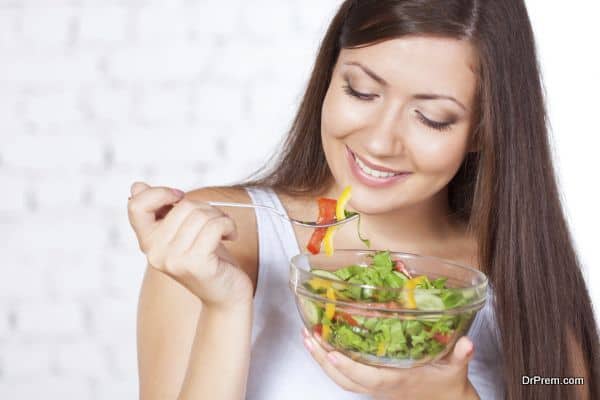 beautiful brunette woman eating salad