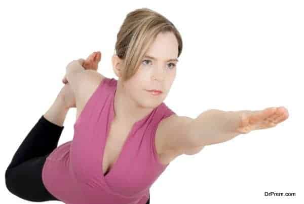 Girl in yoga posiiton on one leg. Studio Shot on white background.