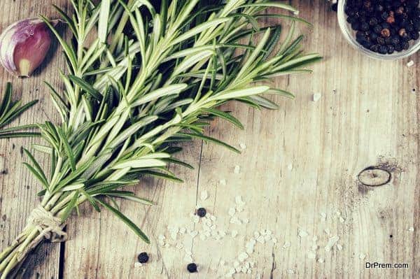 Fresh bunch of rosemary on wooden table.