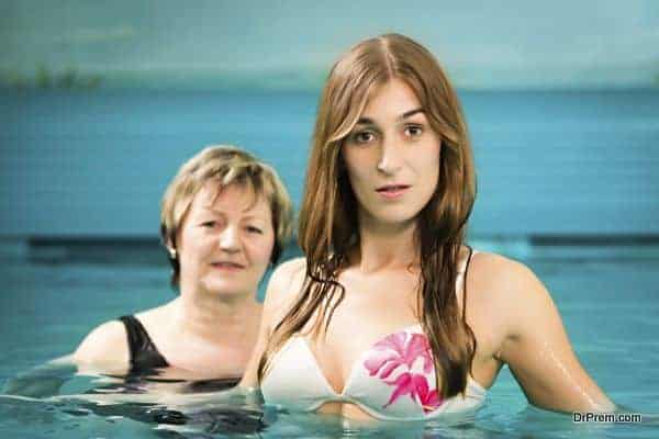 Wellness - mature and young woman in swimming pool