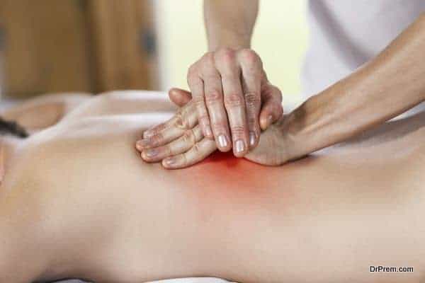 Woman getting back massage at spa