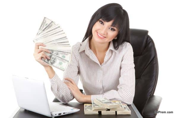 Elegant business woman with pile of money