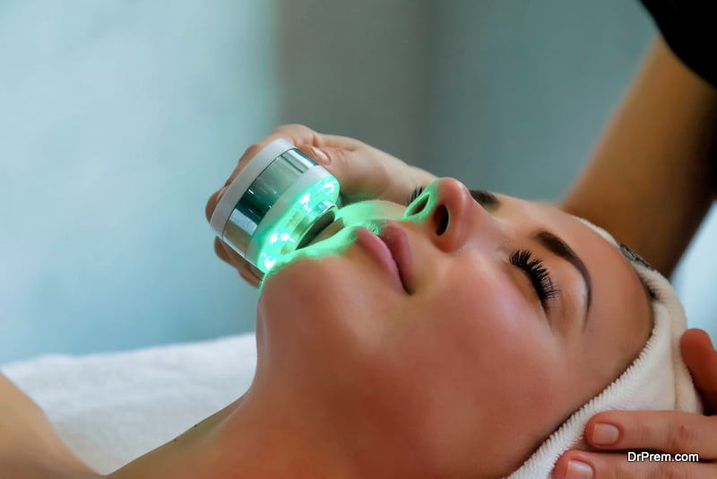 Beautician doing led light therapy to woman in SPA salon