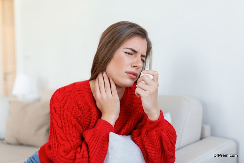 Sick woman sit on bed feel unhealthy blowing running nose