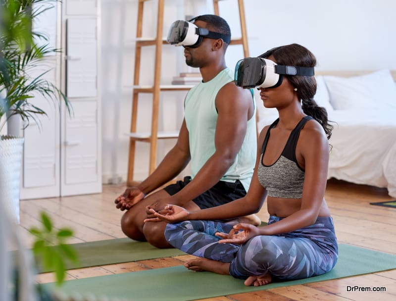 Calm relaxed couple meditating at home, VR goggles 