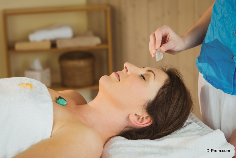 Young woman at crystal healing session in therapy room