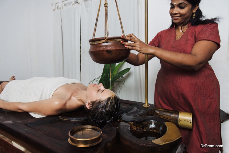 Caucasian woman having Ayurveda shirodhara treatment in India, Kerala state