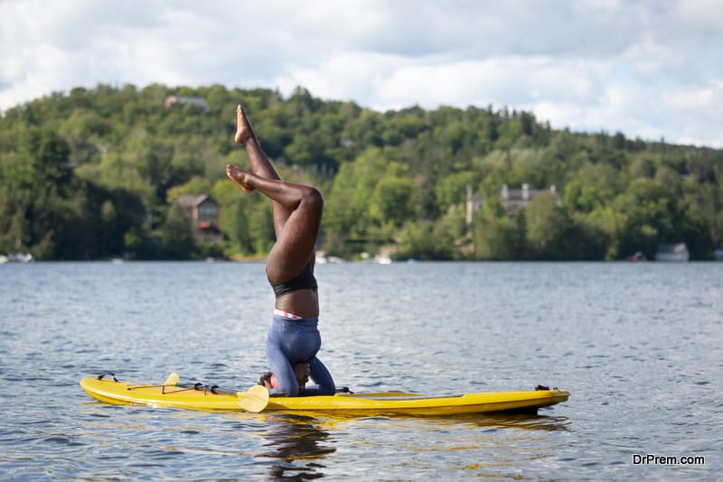 Teenager girls Practicing Yoga on Paddle Board 