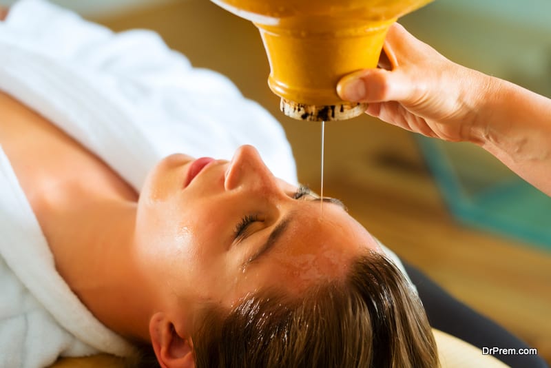 Woman enjoying a Ayurveda oil massage treatment in spa