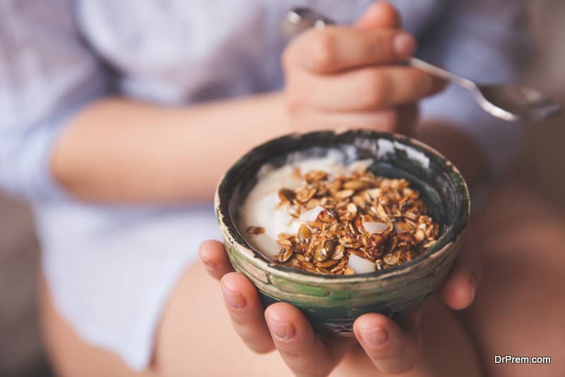 Young woman with muesli bowl