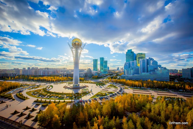 Golden autumn in the capital of Kazakhstan. Modern buildings and blue sky