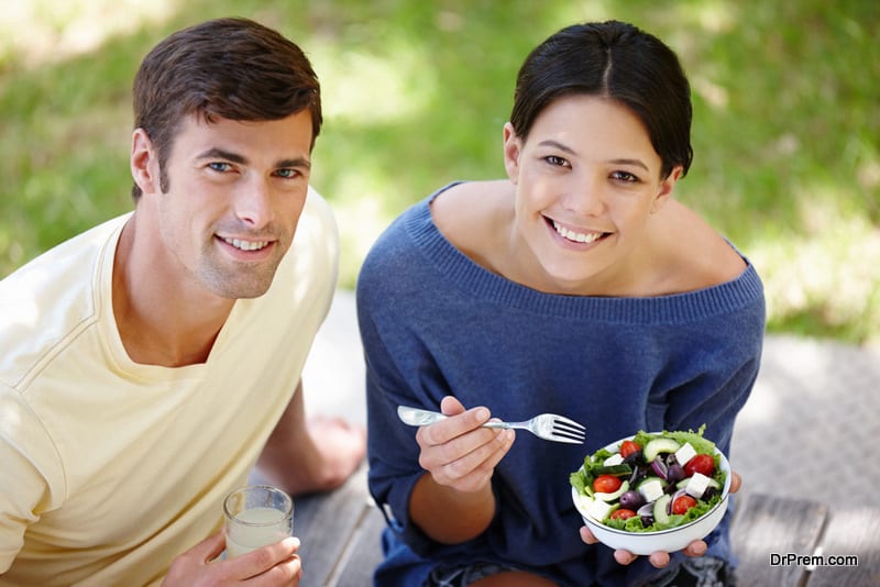 salad-portrait-of-an-attractive-young-couple-sitting-outdoor-on-a-sunny-day