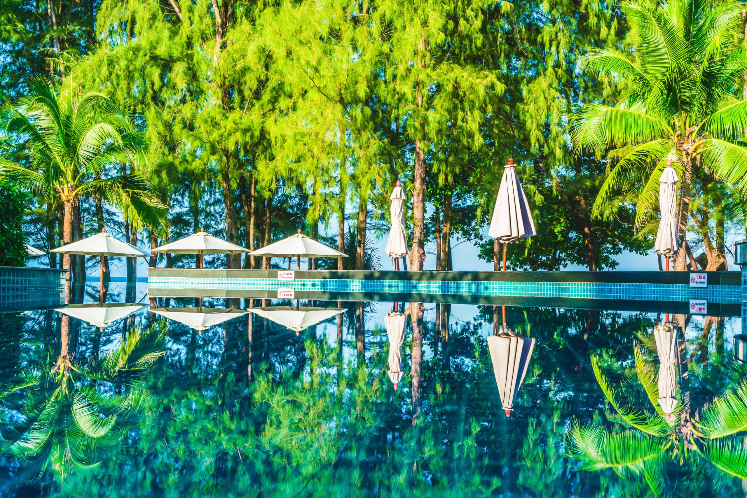 Umbrella and chair around hotel swimming pool resort - Filter effect processing
