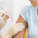 Woman at doctor getting vaccination syringe