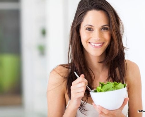 Young woman eating healthy salad