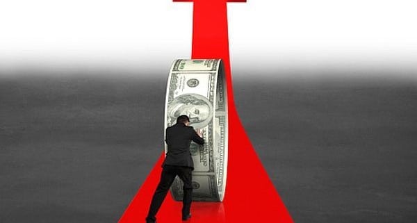 Businessman pushing money circle on growing red arrow