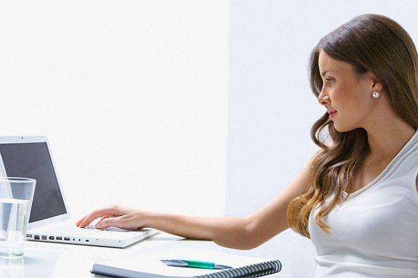 Mixed race businesswoman working at desk