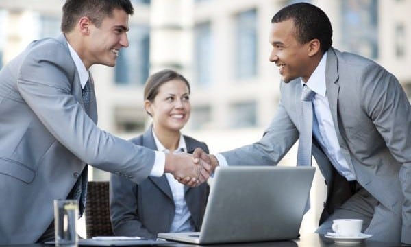 Young business people making a business deal.